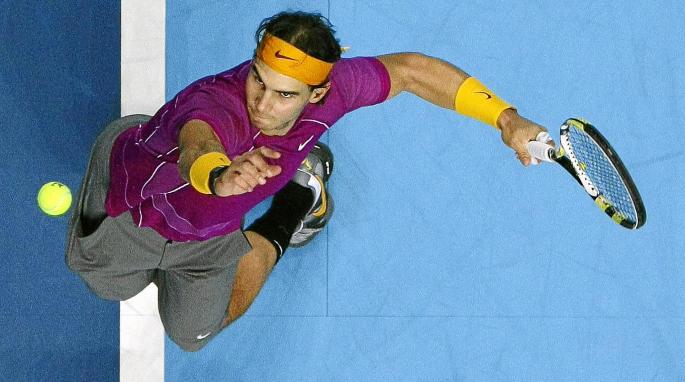 Spain's Nadal serves the ball to Serbia's Djokovic in their singles match at the ATP World Tour Finals in London