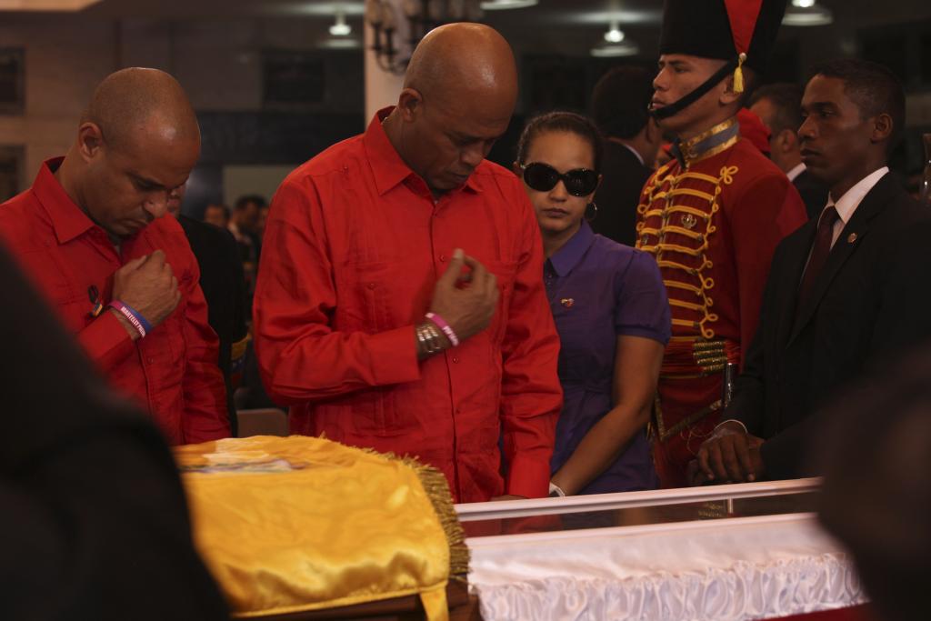 Haiti's President Michel Martelly views the body in state of late Venezuelan President Hugo Chavez in Caracas