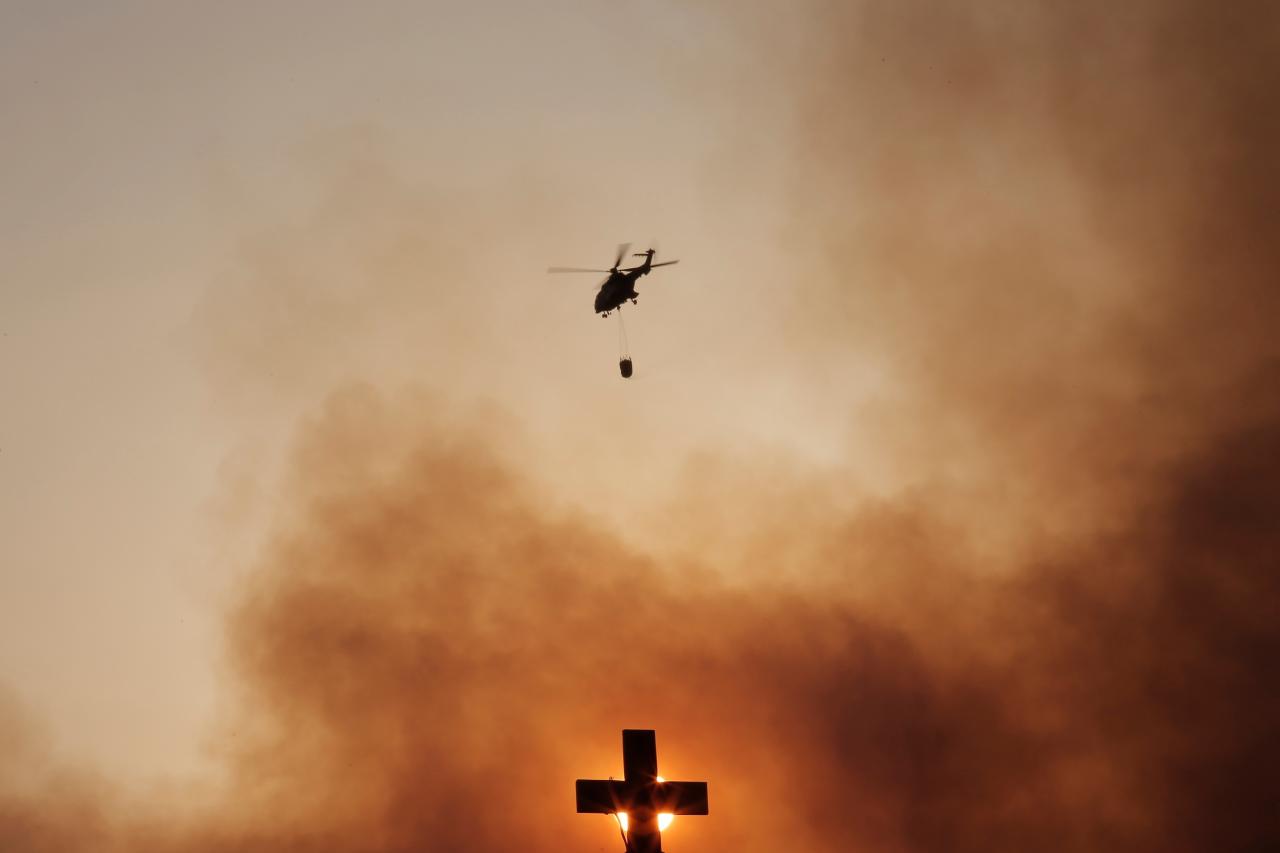 Firefighters battle a wildfire in Kryoneri near Athens Greece