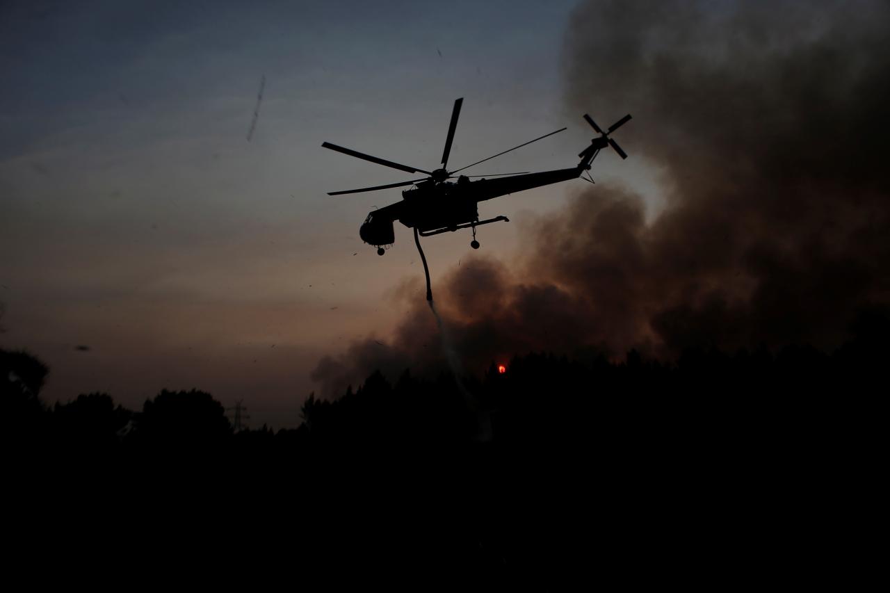 Firefighters battle a wildfire in Kryoneri near Athens Greece