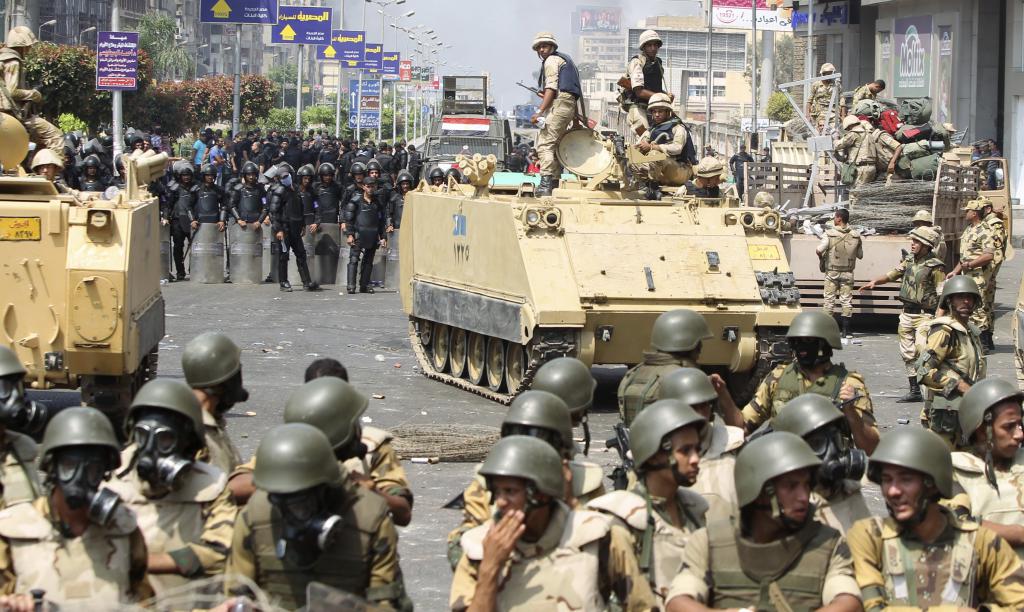 Riot police and army personnel take them up positions during clashes with members of the Muslim Brotherhood and supporters of ou