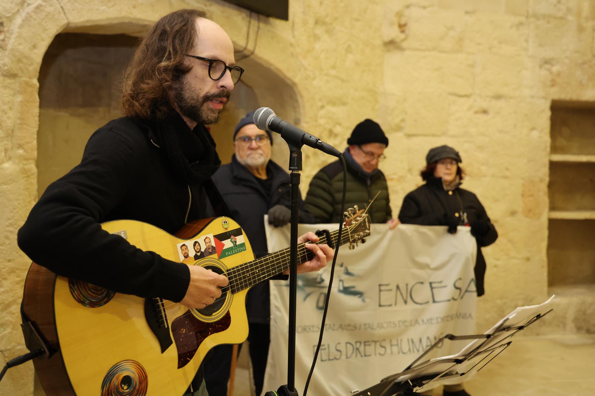 Musician performs at Sant Nicolau Castle during evening event
