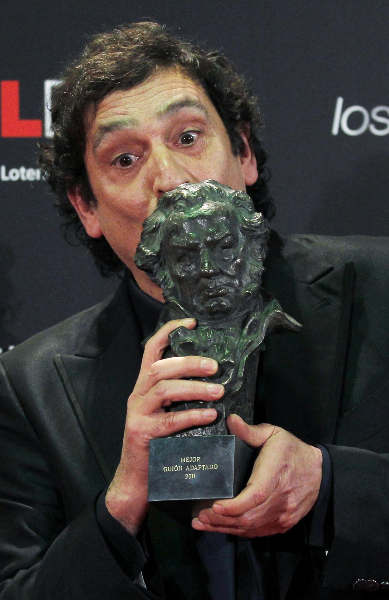 Spanish director Agusti Villaronga kisses his award for Best Director backstage at the Spanish Film Academy's Goya Awards ceremo