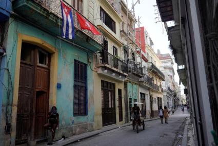 A Cuban flag hangs on the balcony of a house in Havana