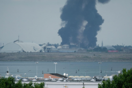 Large clouds of black smoke billows from a chemical plant after an explosion, in Marghera, seen from Venice