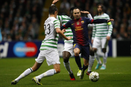 Barcelona's Andres Iniesta runs with the ball as Celtic's Victor Wanyama and Mikael Lustig challenge during their Champions Leag