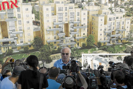 Israeli Housing Minister Ariel speaks to reporters at a ceremony announcing the resumption of construction of an Israeli neighbo
