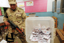 Egyptian army soldier stands guard as officials count ballots after polls closed during final stage of referendum on Egypt's new