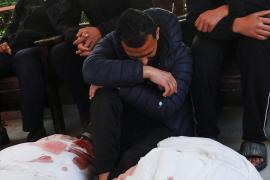 A mourner reacts next to the bodies of Palestinians killed in Israeli strikes, at Nasser hosptial in Khan Younis
